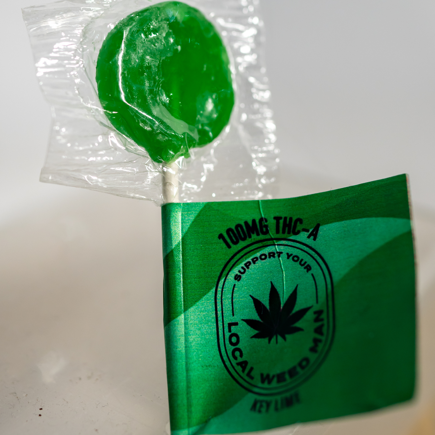 A photo of a 100mg Key Lime Lollipop from Support Your Local Weed Man in the Edible category. Tags: Edibles